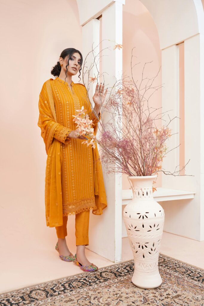 pexels photo 20702673 20702673 Stylish young woman modeling traditional Pakistani clothing indoors by vase with dried flowers.